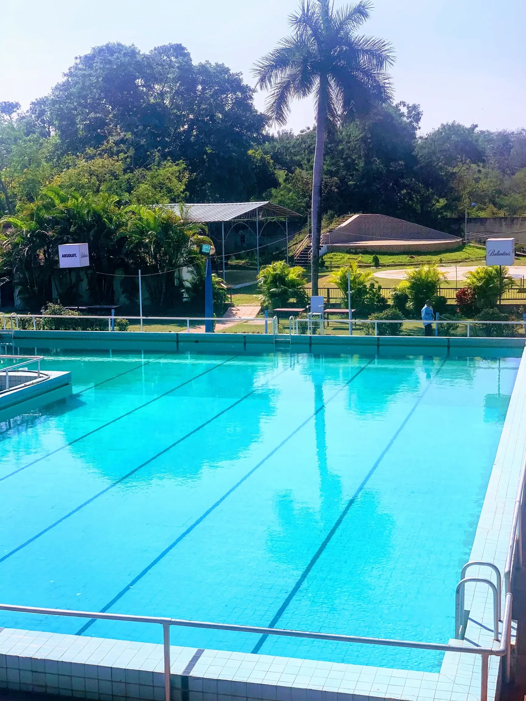 Blue swimming pool with open space to relax poolside